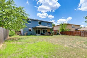 A residential property with a two-story house, a covered patio, and a fenced backyard. - Private Patio & Yard! Bastrop Retreat (Bastrop)