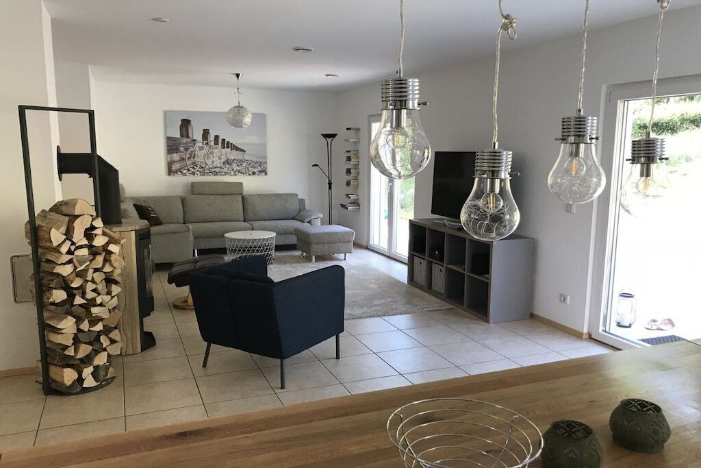A modern living room with a sofa, a coffee table, and a TV stand.