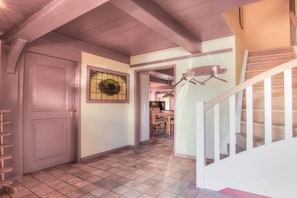 A hallway with a door, a wall-mounted coat rack, and a staircase. - Friesenhaus Sara (S3) (Wenningstedt)