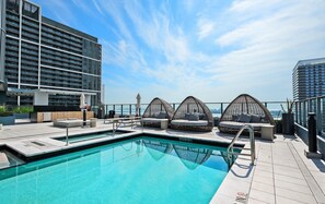 A rooftop pool with a view of a city skyline, surrounded by modern buildings. - 501 First Apartments (Miami)