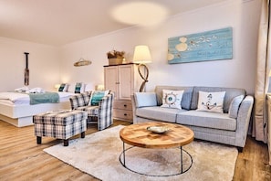 A cozy bedroom with a bed, two sofas, a coffee table, and a dresser. - Apartment in Westerland with swimming pool (Westerland)
