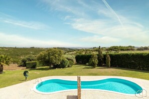 A swimming pool with a clear view of the surrounding landscape. - Villa in Ribamar with swimming pool (Ribamar)