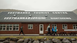 A tourist center building with a sign indicating it is a sightseeing location.