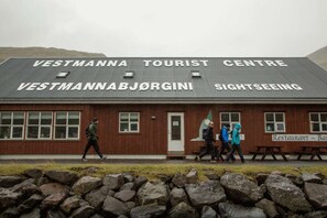 A tourist center building with a sign indicating it is a sightseeing location. - 5BR Charming Villa with Stunning Views - 9 guests (Vestmanna)