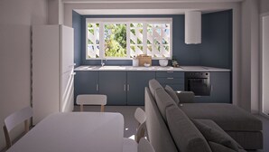 Cocina moderna con comedor, horno integrado y ventana con vistas a la vegetación.