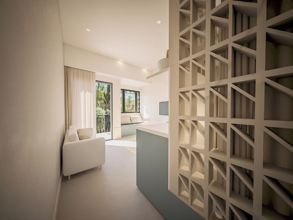 A modern interior with a sofa, a desk, and a patterned wall. - KALI by Zoia Living (Kallithea)