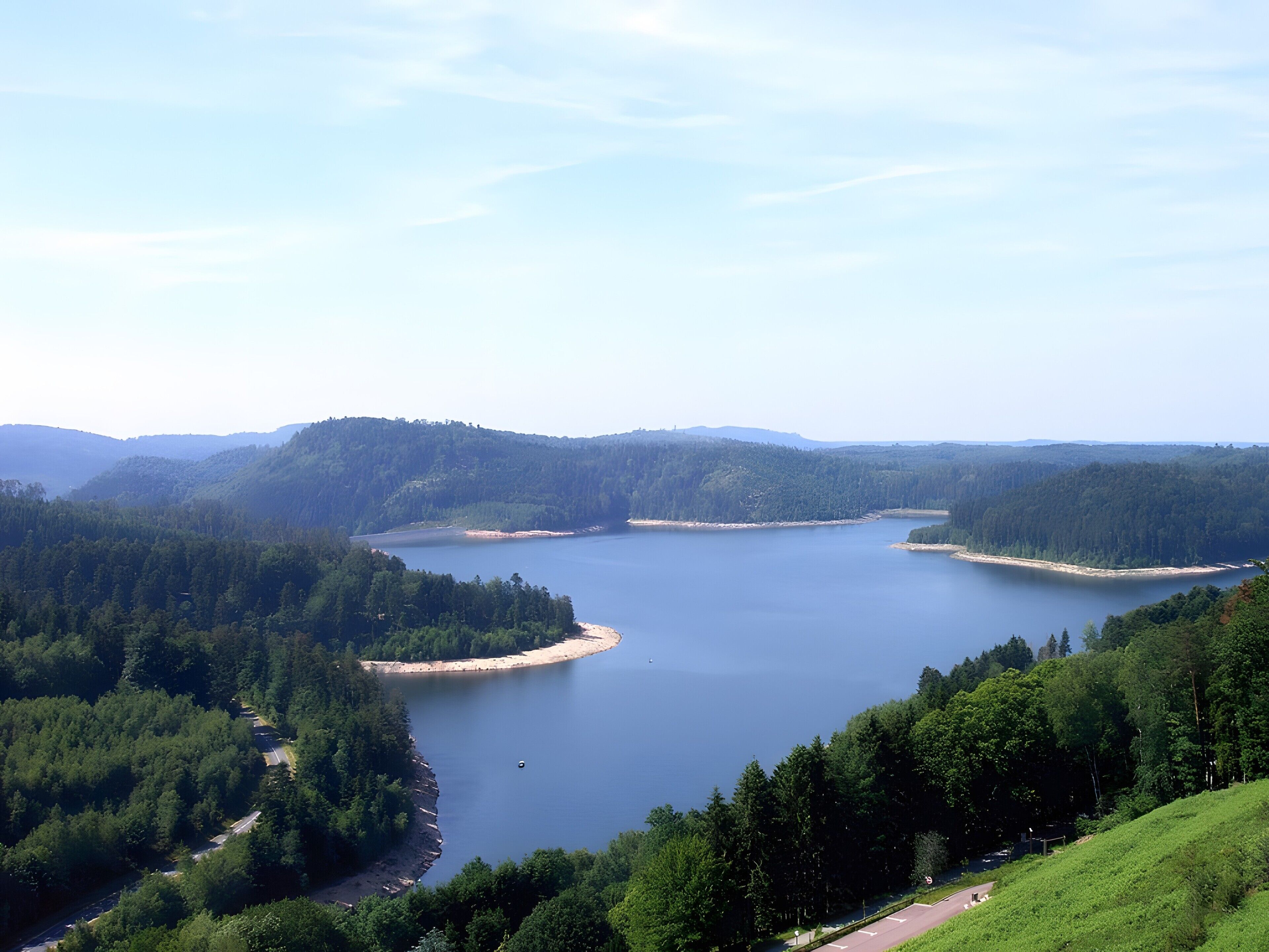 A lake surrounded by forested hills.