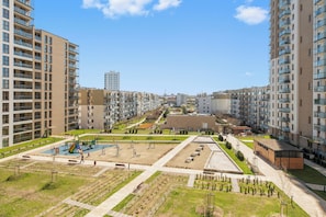 A residential area with modern apartment buildings, a playground, and a landscaped park. - Nowa Letnica - Gdansk Seaside (Gdańsk)