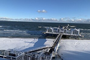 A pier extending into the sea with a building at the end. - "Baltic Sea Love" Villa Lena Wilhelmstrasse (Sellin)