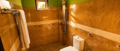 A bathroom with a shower, toilet, and sink.
