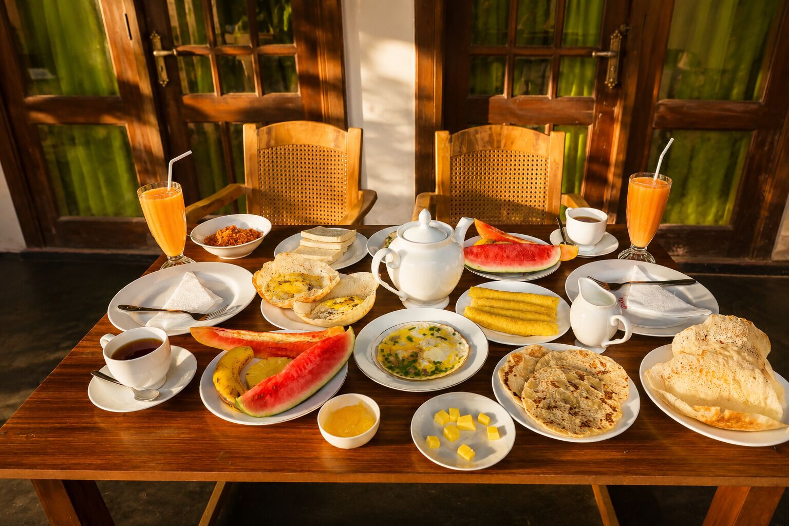 A breakfast table with various dishes including toast, eggs, and fruit.