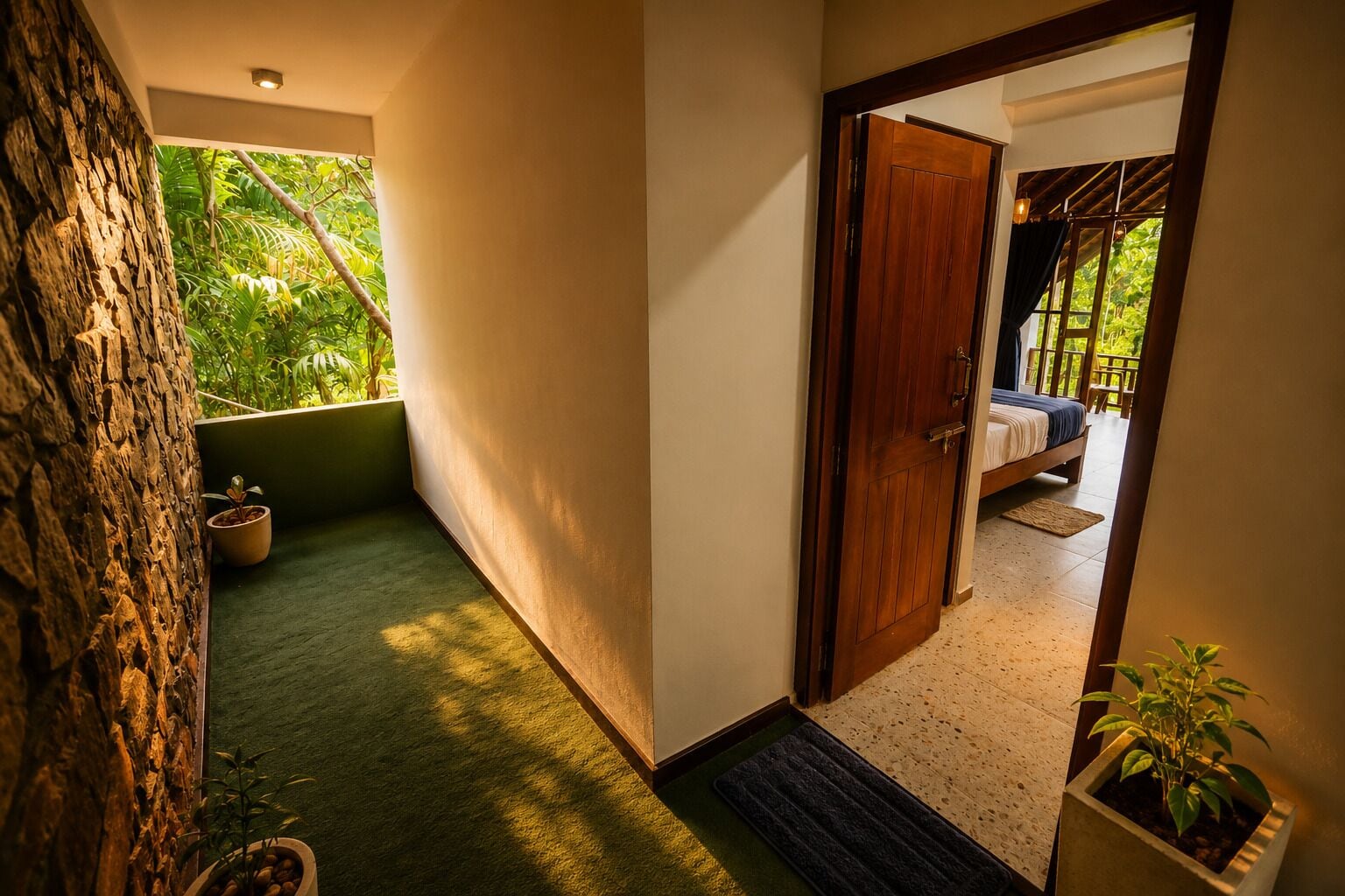 A hallway leading to a bedroom with a view of greenery outside.