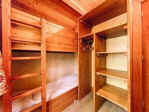 A wooden bunk bed with a mattress and a wooden wardrobe with shelves. - Aesthetic Wooden Cottage in Slagharen (Slagharen)