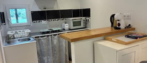 A modern kitchen with a microwave, toaster, and coffee maker.