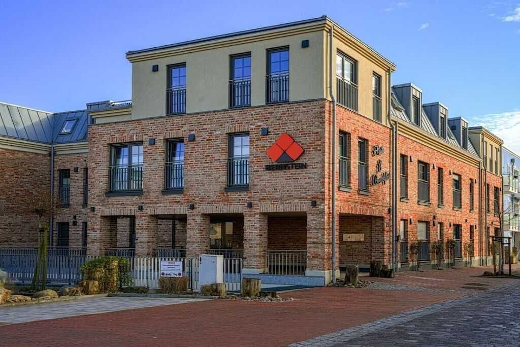 A brick building with a flat roof and a red logo.