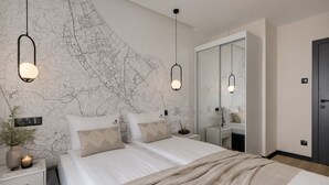 A modern bedroom with a large bed, bedside tables, a nightstand, a mirror, and a map on the wall. - Nowa Letnica - Gdańsk Panoramic View  (Gdańsk)