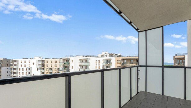 A balcony with a view of adjacent buildings.