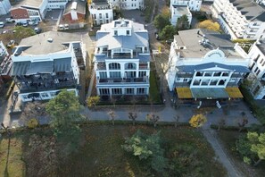 A multi-story building with a central courtyard, surrounded by other buildings. - Holiday apartment in Binz with swimming pool (Binz)