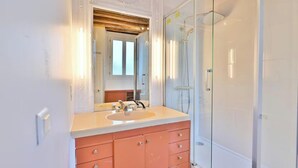 A bathroom with a large mirror, a sink, a shower, and a cabinet. - AN EXCELLENT COMBINATION OF PARISIAN CHARM & CENTRAL CONVENIENCE - SAINT GERMAIN (Paris)