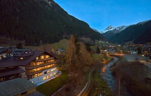 A mountain village with traditional buildings, a river, and a road. - Modern Suite With Conservatory (Gaschurn)
