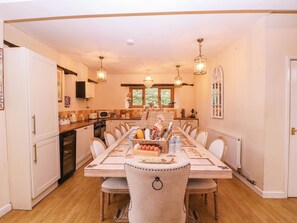 A dining room with a long table, chairs, and a central decorative piece. - The Warm Hearth: 15 Acre Countryside Estate (Hereford)