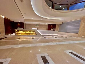 A modern lobby with a reception desk, a decorative wall feature, and a high ceiling with recessed lighting. - Superior Checkin Amritsar (Amritsar)