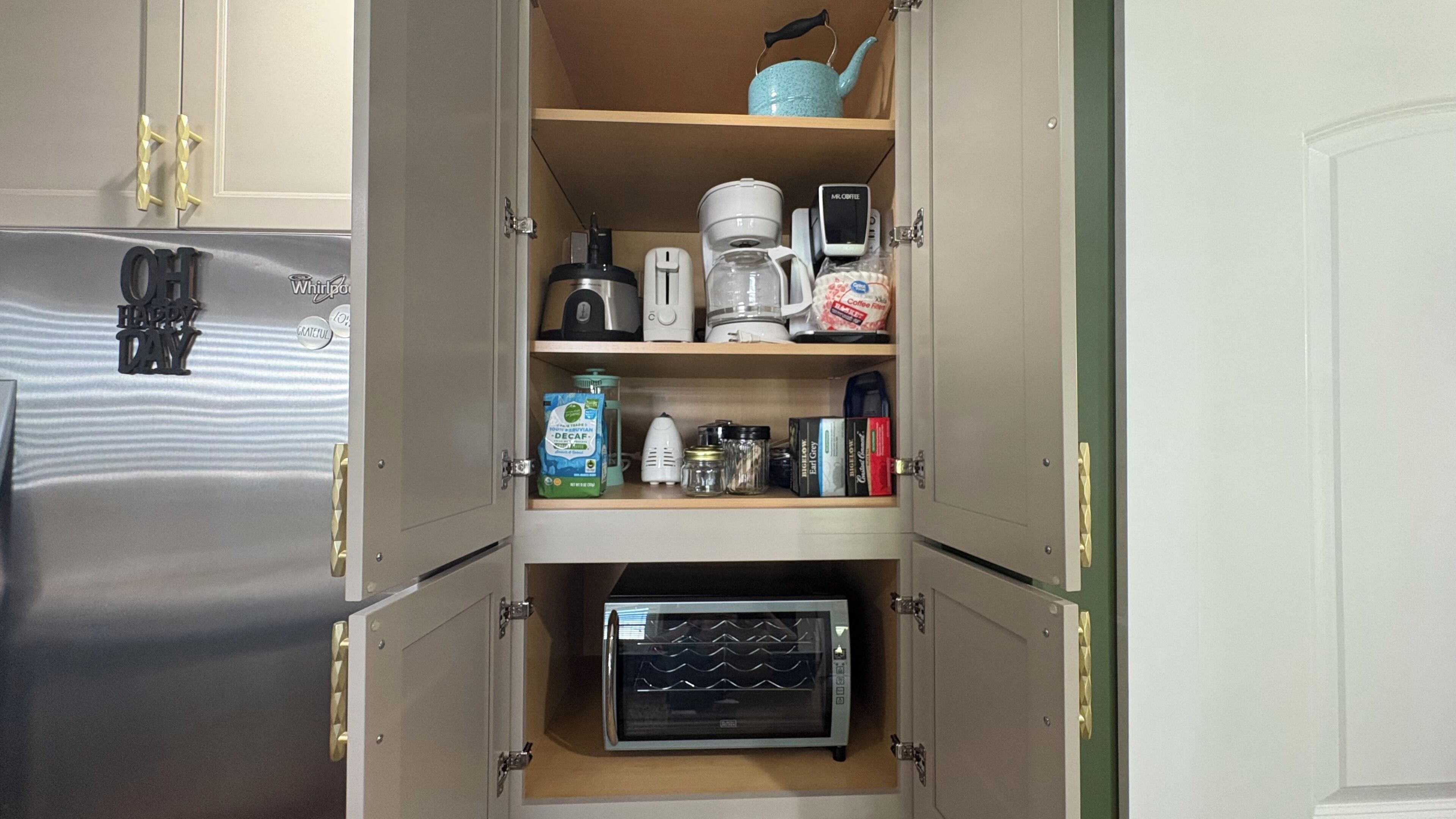A kitchen with a built-in microwave, coffee maker, and various kitchen appliances.