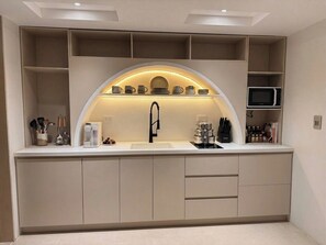 A modern kitchen with built-in appliances, a microwave, and a sink. - Provenza's Top Apt w/ Jacuzzi, AC, WD, Elevator, Located in the Best Area (Medellín)
