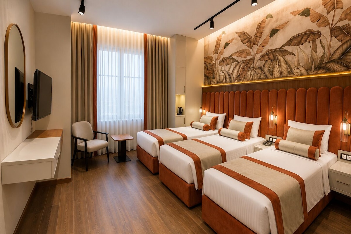 Een hotelkamer met twee bedden, een bureau, een stoel, een televisie en een groot wanddecor.