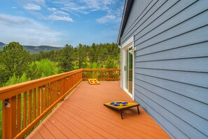 A wooden deck with a view of a forest and mountains. - Blue Sky Retreat w/ 3rd-floor Mtn Views, Starlink (Bailey)