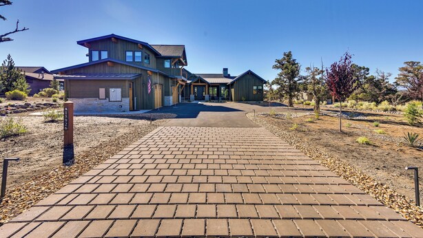 A two-story house with a paved driveway leading to the entrance. - Golf Views, Resort Pool Access! Brasada Ranch Home (Powell Butte)