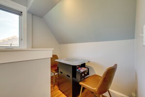 A small room with a sloped ceiling, a window, a desk with a computer, and a chair. - Walk to Capitol Campus! 'stellar & Bloom Olympia' (Olympia)