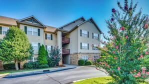A multi-story residential building with a central courtyard, balconies, and a well-maintained lawn. - Condo on Lake Hartwell 3 Mi to Clemson Stadium (Seneca)