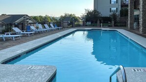 A rectangular swimming pool with a 3-foot depth marker, surrounded by lounge chairs and a stone wall. - Condo on Lake Hartwell 3 Mi to Clemson Stadium (Seneca)