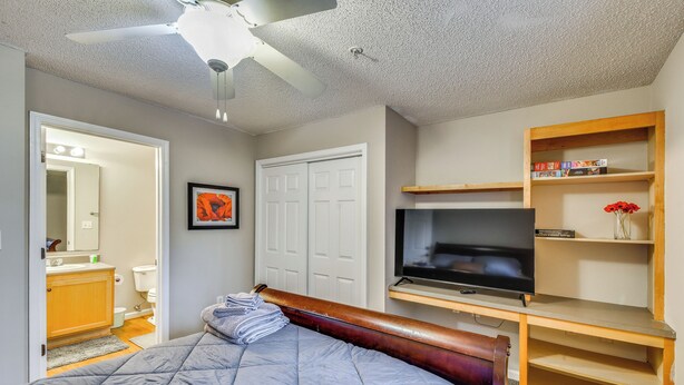 A bedroom with a bed, a television, a wardrobe, and a ceiling fan. - Condo on Lake Hartwell 3 Mi to Clemson Stadium (Seneca)