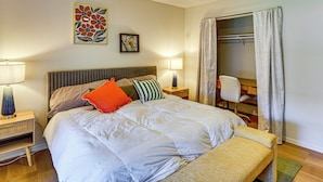 A hotel room with a bed, bedside lamps, a bench, a wardrobe, and two framed floral artworks on the wall. - Remote Work Ready! Walkable Fayetteville Home (Fayetteville)