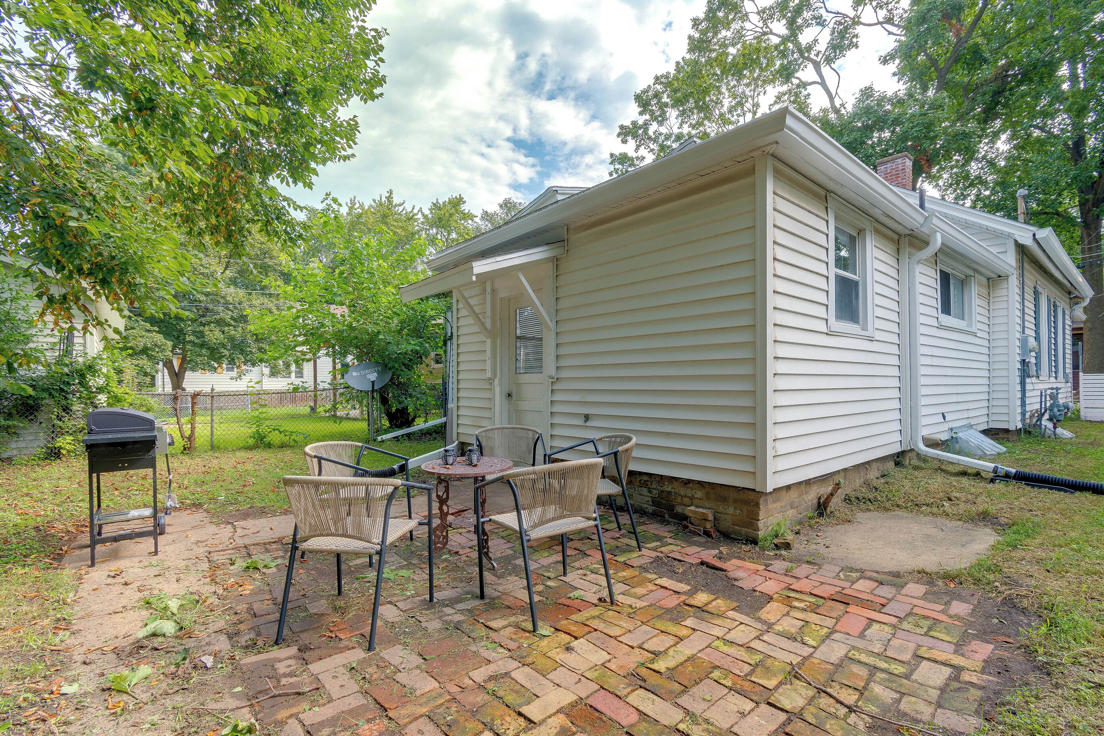 A small house with a patio area featuring a table and chairs.