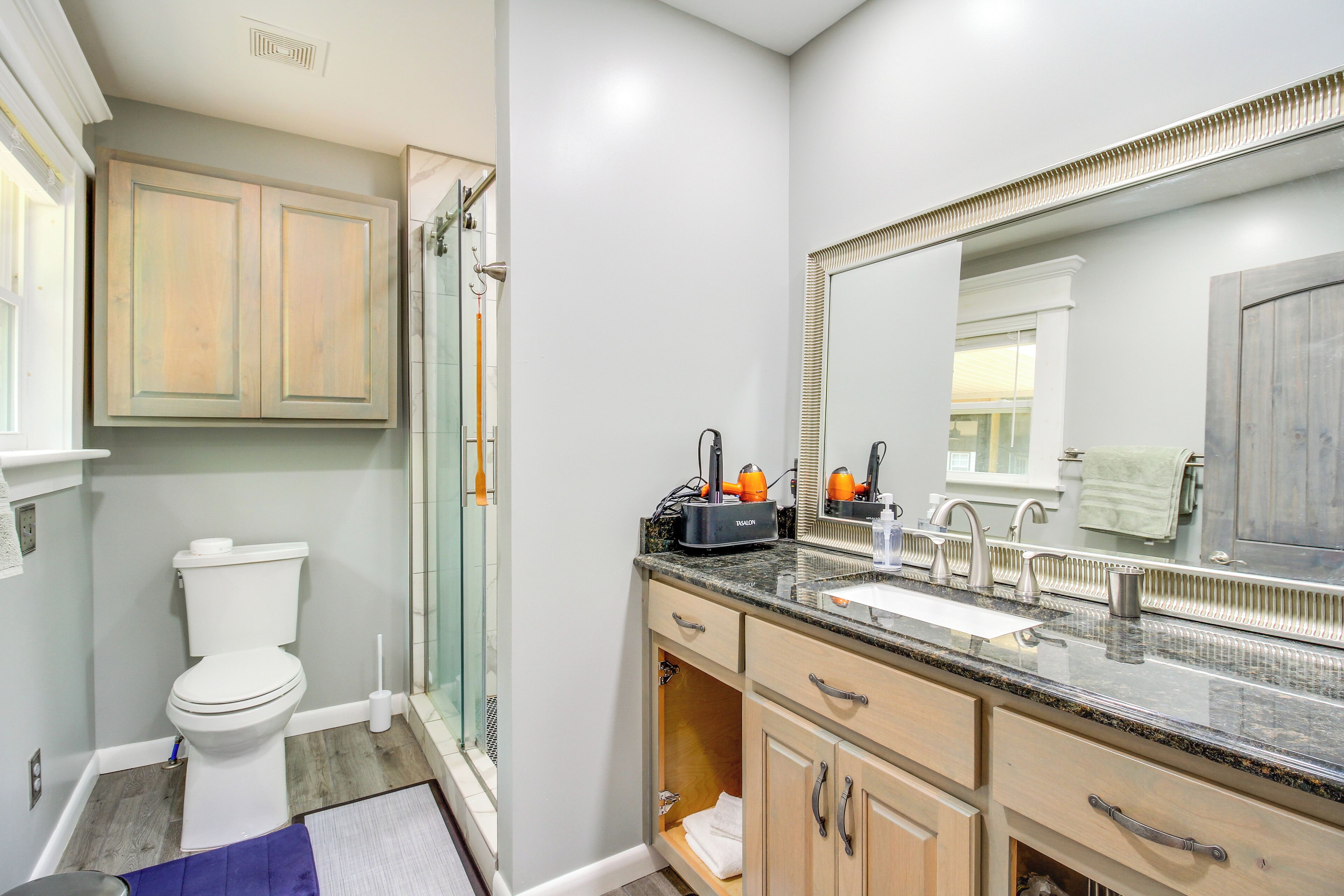 A bathroom with a toilet, sink, and shower.