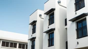 A modern building with multiple floors, large windows, and a flat facade.