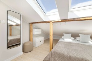 A modern bedroom with skylights, a bed, a wardrobe, and a mirror. - Spacious 2-Bedroom Apartment | Air-conditioning | City Centre (Lublin)