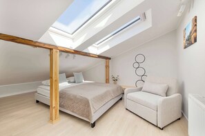 A bedroom with a skylight, a bed, a chair, and a radiator. - Spacious 2-Bedroom Apartment | Air-conditioning | City Centre (Lublin)