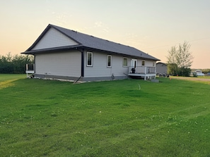 A single-story house with a front porch, a garage, and a well-maintained lawn.