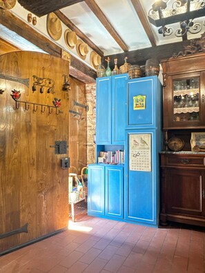 A room with a wooden door, a blue cabinet with shelves, and a wall-mounted calendar. - A Unique Tuscan Hideaway in Camaiore (Camaiore)