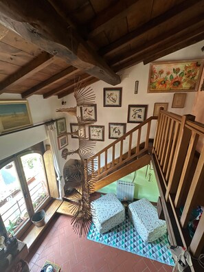 A staircase with wooden railings leading to a lower level, surrounded by framed pictures on the walls. - A Unique Tuscan Hideaway in Camaiore (Camaiore)