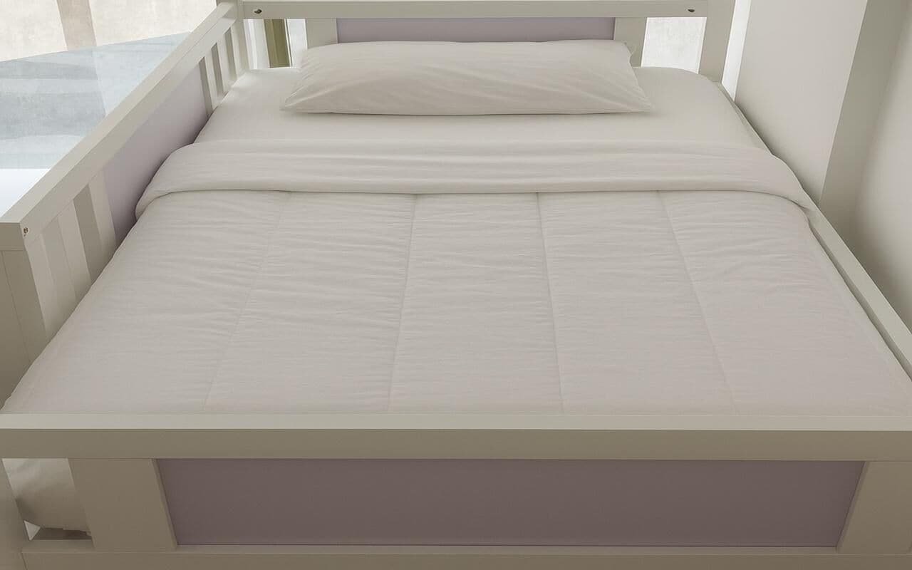 A white bed with a headboard, a pillow, and a mattress.