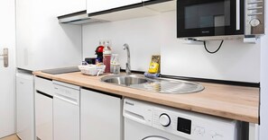 A modern kitchen with a sink, a microwave, and a dishwasher. - Apartment 'Calypso' with Shared Pool, Wi-Fi and Air Conditioning (Mijas)
