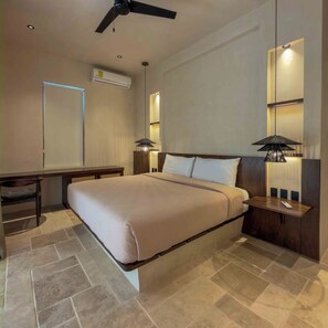 A modern hotel room with a bed, bedside table, lamp, and ceiling fan. - 10-bedroom- all Suites - Wellness Compound - Private Sauna/Ice Bath/Yoga Deck (Tulum)