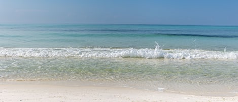 A beach with clear turquoise water and white sand.