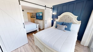 A bedroom with a bed, a nightstand, a dresser, and a painting on the wall. - Islander Beach Resort 0607 1 Bedroom Condo (Fort Walton Beach)
