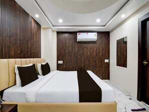 A modern hotel room with a large bed, wooden panel walls, an air conditioning unit, and a marble floor. - Classic With View Mivaan Comfort (Barasat)